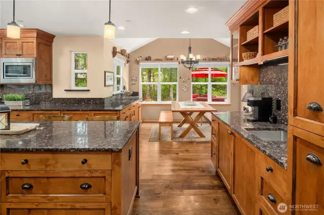 Coffee Bar with sink, beverage fridge (disguised with cabinet front!), open cabinet storage and glass front shelves. Pull out the shelves on the far right for a suprisingly large pull-out pantry! So well designed!