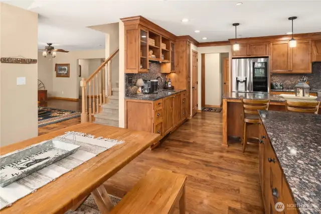 Fron Breakfast Nook towards kitchen, living room and stairway to upper level.