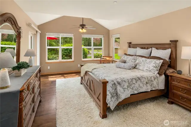 Large main floor Primary Suite with door leading to the deck. Partial vaulted ceiling.