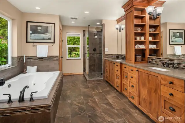 Remodeled 5-Piece Primary Bath. Double vanity with lots of storage and convenient "in drawer" hair dryer outlets. Over-sized spa-style jetted tub. Large walk-in shower. Separate toilet room.  Roomy walk-in closet with built-in shelves and drawers. Tile floors.