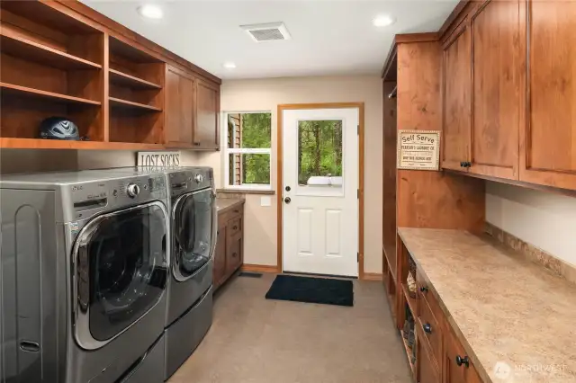 Main floor mud room and laundry room. Lots of cabinets, countertop and coat/boot storage!