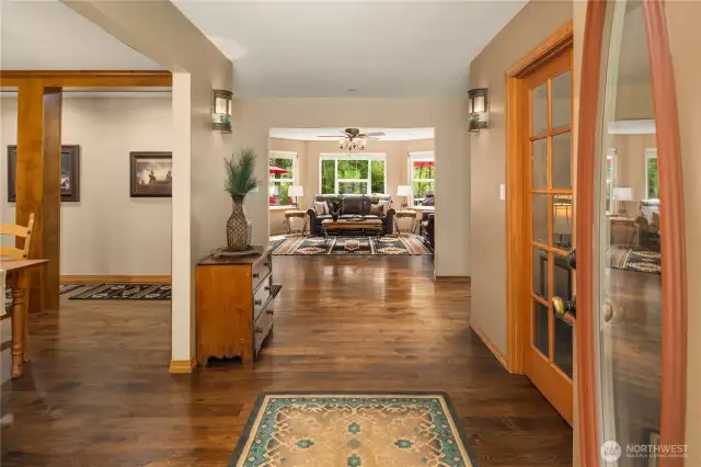 Welcome! Gorgeous walnut hardwood floors throughout the main level. Wide entry hall flanked by the office and formal dining room.