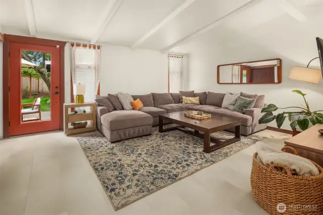 The expansive great room offers direct access to the patio and pool area, with windows that fill the space with natural light.