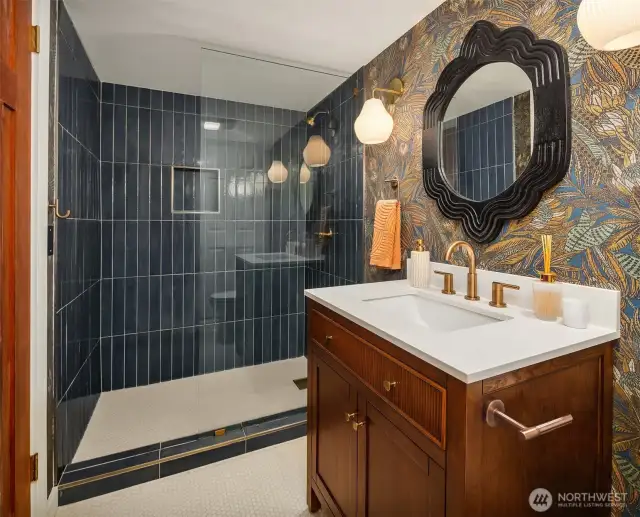 The 3/4 bath shines with sophisticated, high-end finishes that create a sleek, contemporary vibe.