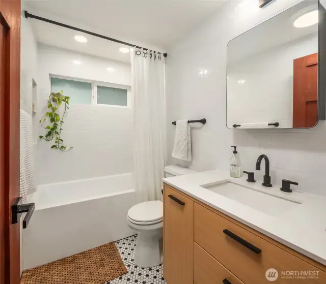 A beautifully updated full bath with a fresh, spa-like vibe—featuring sleek finishes, soothing tones, and a relaxing ambiance that invites you to unwind.