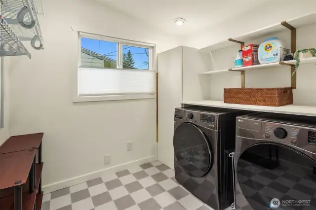 Bright and spacious utility room with ampul storage for added connivence.