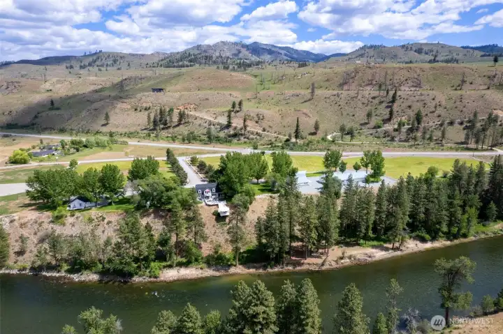 Overhead View: From above, Marble Ranch showcases expansive grounds, a long tree-lined drive, and a charming home nestled among rolling hills.