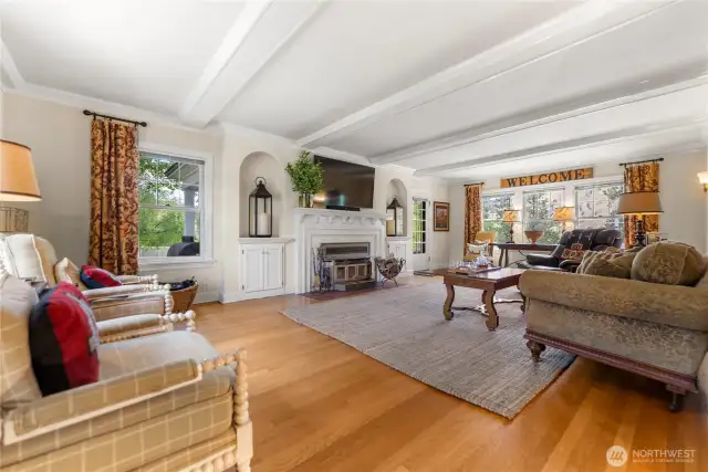 Elegant living room with coved ceilings, oak floors, and abundant natural light—ideal for relaxing or entertaining.