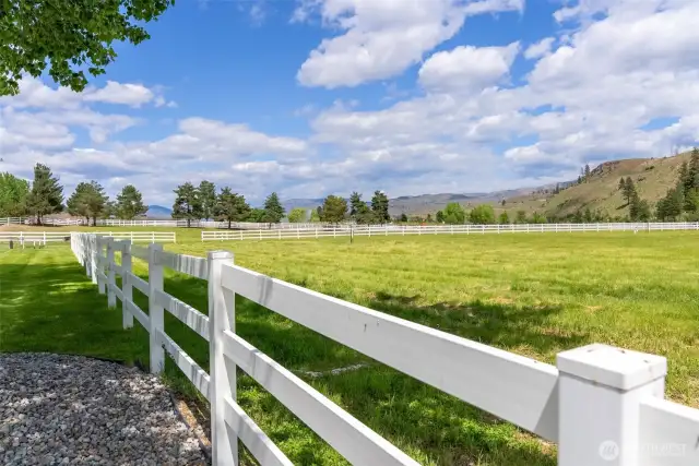 Irrigated pasture framed by white fencing and open sky—an idyllic pastoral setting for livestock, hay, recreation, or simply soaking in the Methow’s peaceful rhythm.
