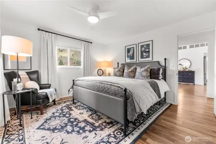 Light-filled and peaceful, the guest house primary room offers a cozy retreat with scenic views.