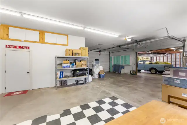 Insulated workshop with workbenches, bathroom, air compressor system, and plenty of space for projects or business use.  Plus, spacious 3-bay equipment garage with built-in shelving, storage, and attached office—ideal for tools, trucks, and weekend projects.