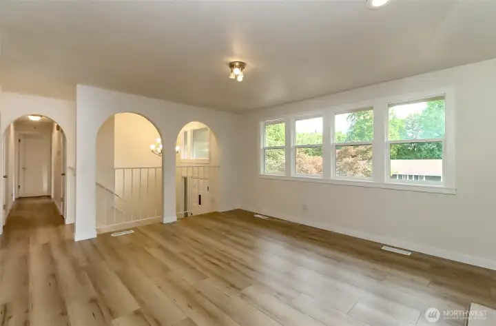 Main level living room with new LVP flooring throughout the home
