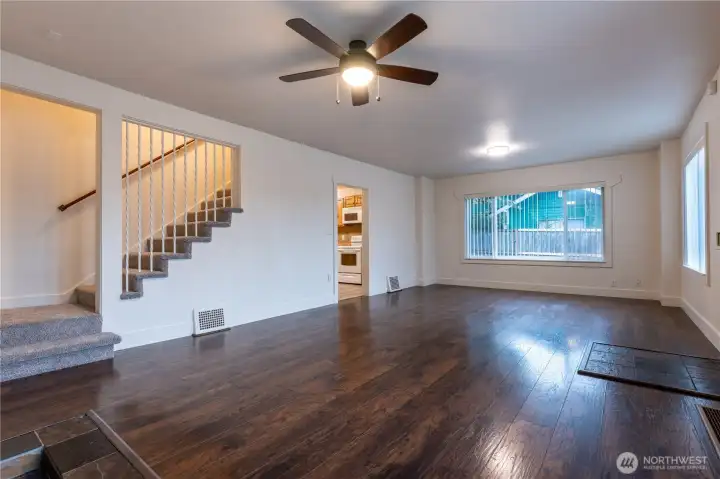 Large, great room style living and dining room leads to the kitchen.