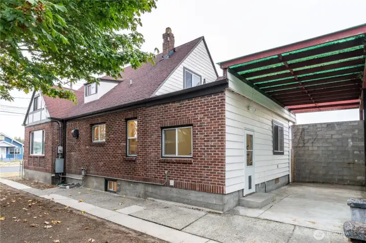 Side view of home and covered patio.  The flat roof portion of the home is one year old.
