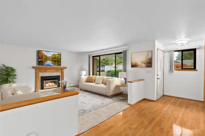 Large front room (virtually staged) with new carpet and gas fireplace