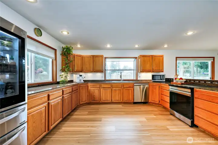 Kitchen with new appliances, including induction stove. Tons of cabinets and counter space with a pantry too.