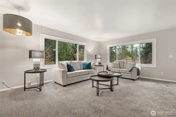There's so much room in this formal living room! And look at those gorgeous, large vinyl windows carrying the outdoors, inside!
