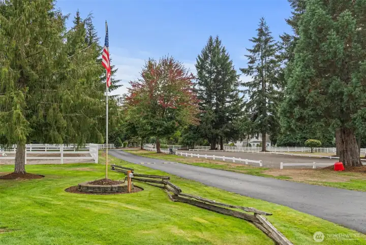 The entrance offers a combination of elegance, professionalism, and warmth, providing a meticulous, welcoming first impression.  Note: On right side of drive is a 50 x 150 dressage arena.