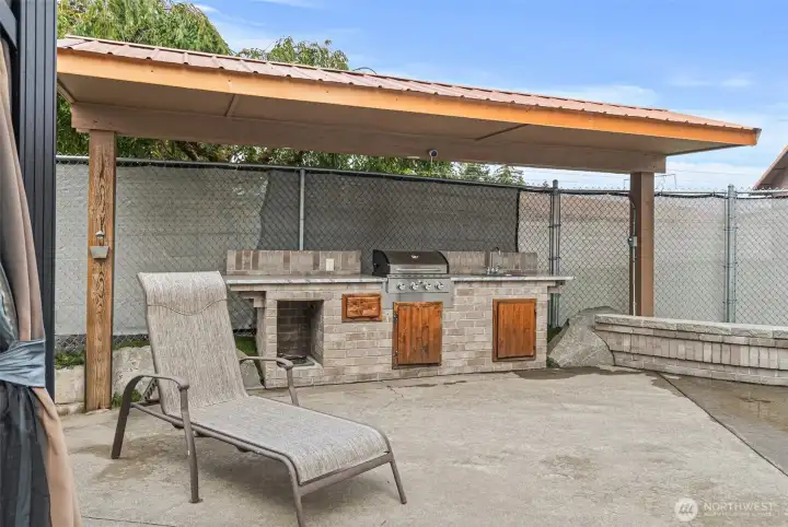 Covered outdoor kitchen by the pool is the perfect setting for hosting large gatherings and celebrations.
