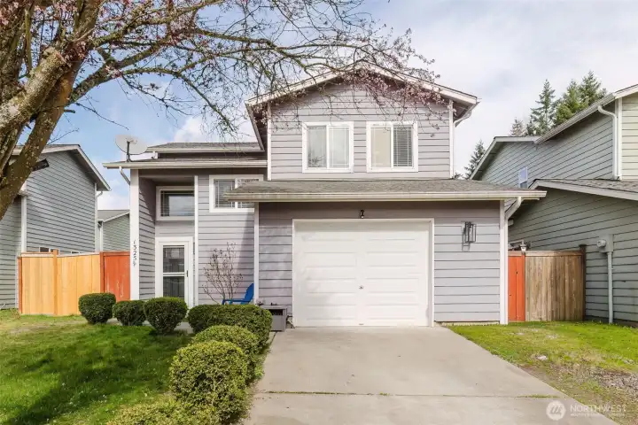 Welcome home!  Front of house faces the south so you have all day natural light through all the front windows.  Boxwood hedge lines the driveway and leads up to the front door.
