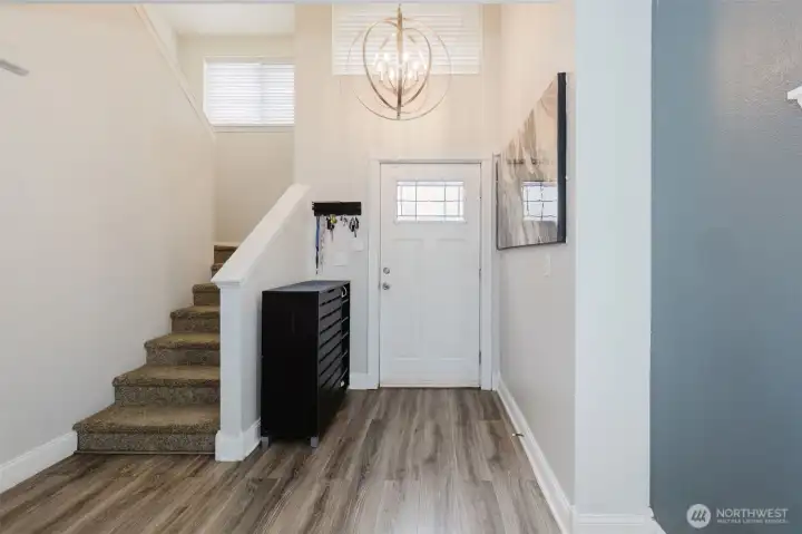 Bright foyer with southern facing windows is so welcoming.  As you enter, you will notice the warm radiant floors that heat the main floor.