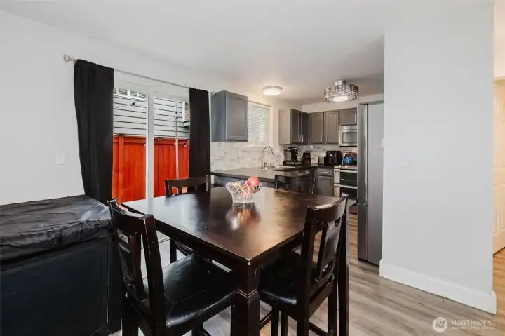 Dining room and eat-in kitchen with sliding glass door leading to the back patio.