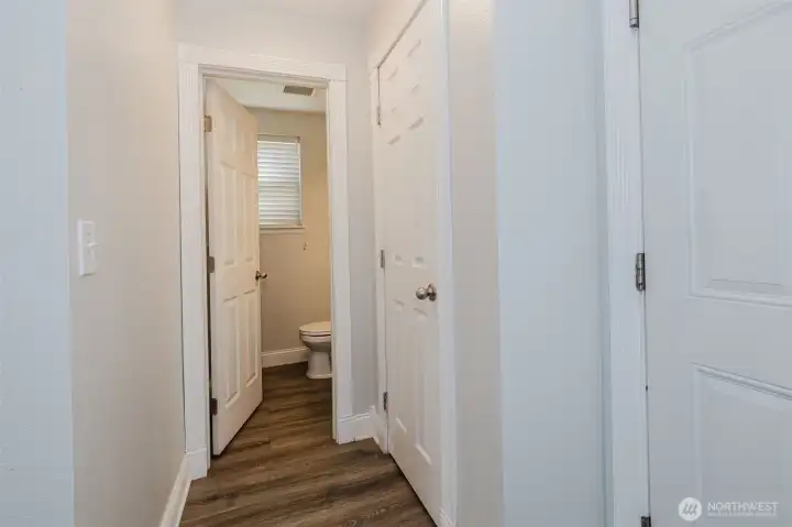 Hallway to garage, pantry, and guest half bath.