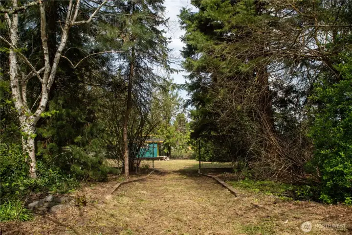 Wide walkway the leads to North side, which is over the seasonal creek to your right and left.