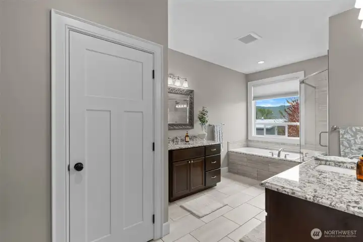 Primary bathroom with large soaking tub and walk in shower.
