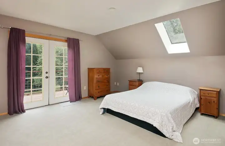 Spacious upper level primary suite with private kitchenette and French doors that open to a private deck.. Spacious upper level primary suite with private kitchenette and French doors that open to a private deck..