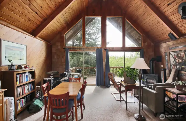 Guest house, upper level. Light-filled living and dining area with a slider to the deck. Guest house, upper level. Light-filled living and dining area with a slider to the deck.