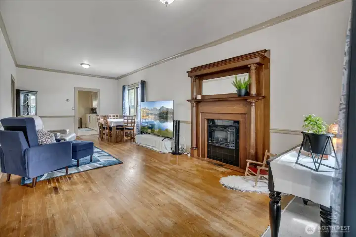 Wood wrapped brick fireplace. Hardwood floors