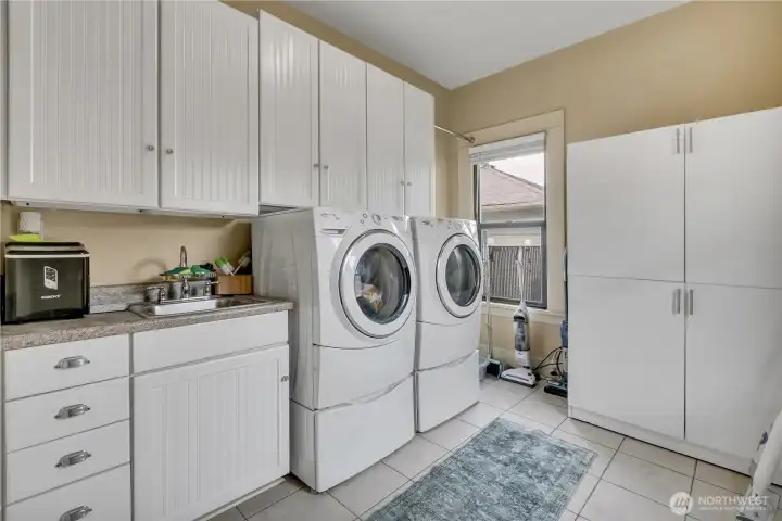 Laundry room with ample storage and Washer Dryer are included.