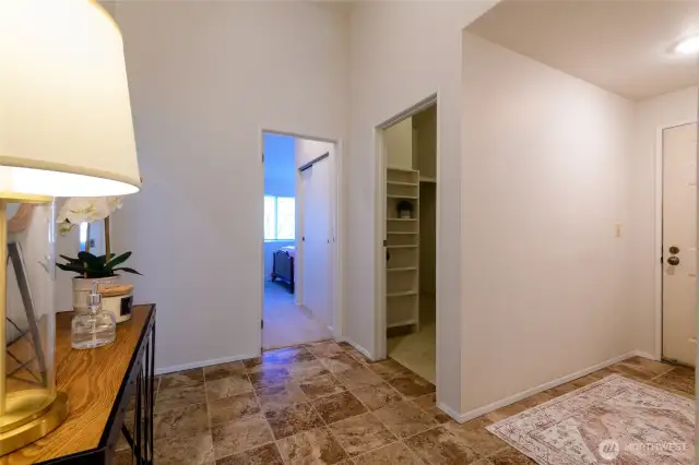 From the entry, this view is looking to the laundry room at right and two of th three bedrooms.