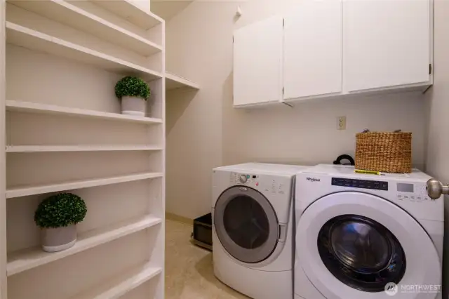 The laundry room offer tons of storage space and can double as a pantry. Washer an dryer stay.