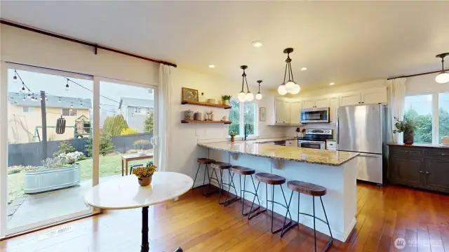 Eating area looking back toward kitchen and out to fully fenced backyard