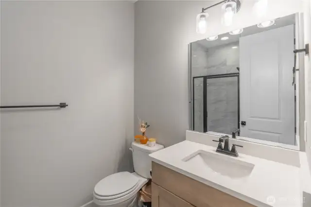 Main level bath off of entry and den