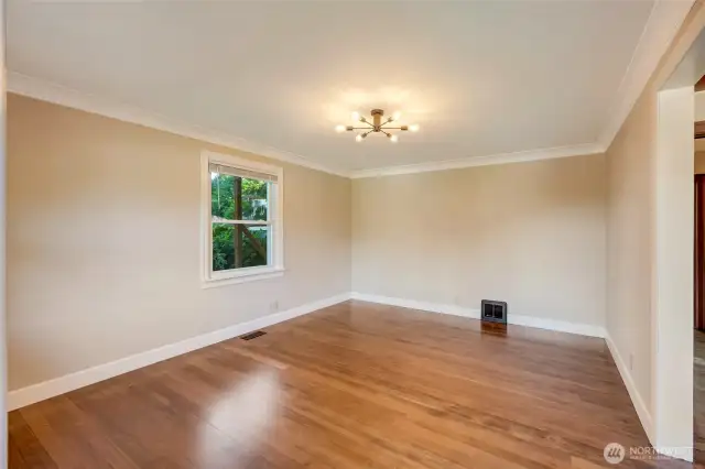 Living room with real hardwood floors, double pane windows, and updated lighting.
