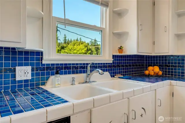 Tile backsplash with large, double sink.