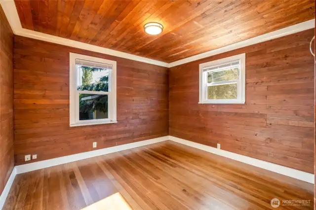 Second bedroom on main floor embraces the original wood.
