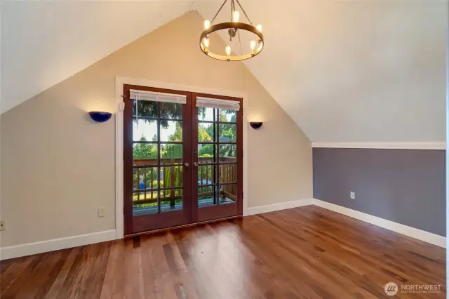 Primary bedroom with water view balcony outside the french doors.
