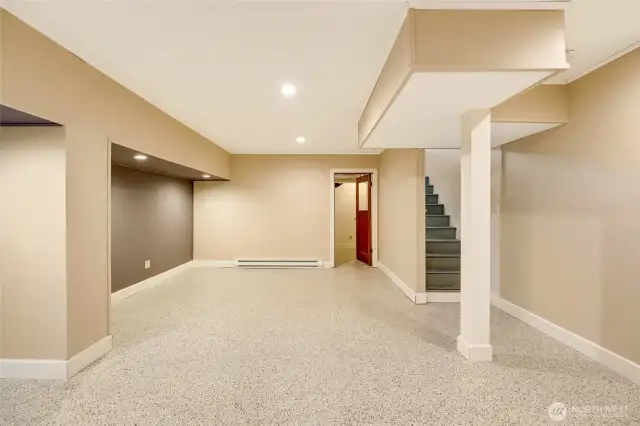 Newly finished basement with utility room to the back.