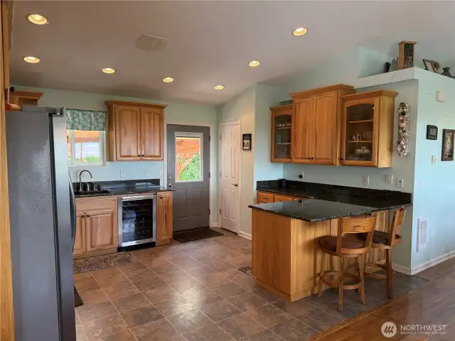 More cabinets, counterspace with beautiful granite countertops. Room to setup a buffet for entertaining.