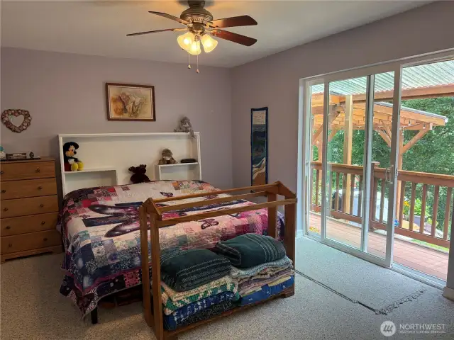 Primary bedroom with access to the wrap-around deck.