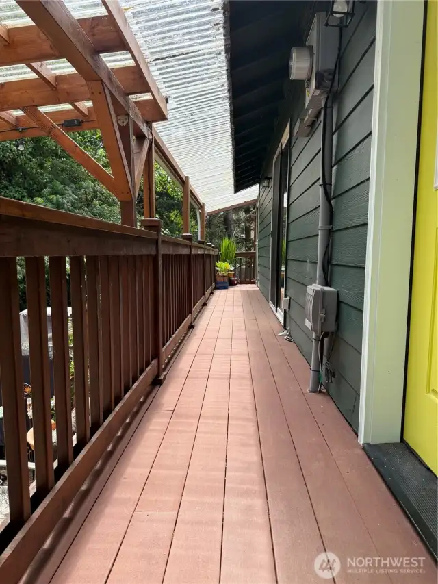 Back deck leads to laundry outbuilding and gazebo.