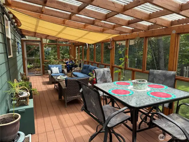 Dining in the sunroom.  This is a part of the wrap-around deck with doors on front and back.