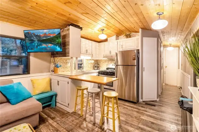 Kitchen with full size appliances and bar height dining area