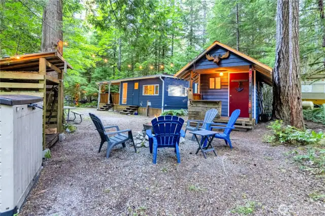 Fire pit, plastic storage shed, wood shed and powered shed