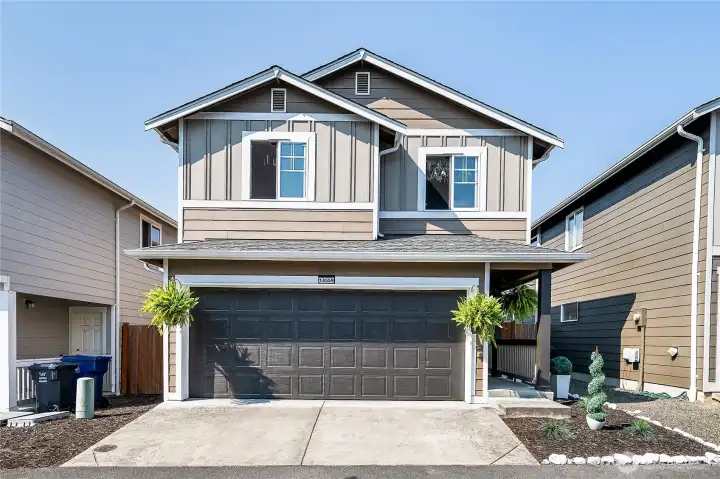 Large alley access to the 2 car attached garage and sweet covered walkway.