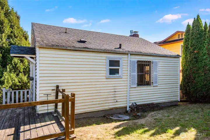 This photo shows the backyard and side entry to the home.